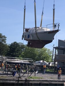 Image of boat being hoisted by crane
